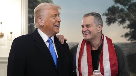 US President Donald Trump greets Marc Fogel at the White House, February 11, 2025.