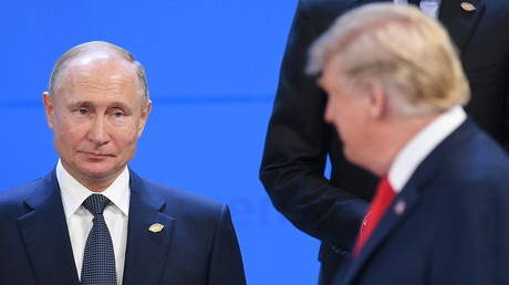 Russian President Vladimir Putin, left, looks at US President Donald Trump.