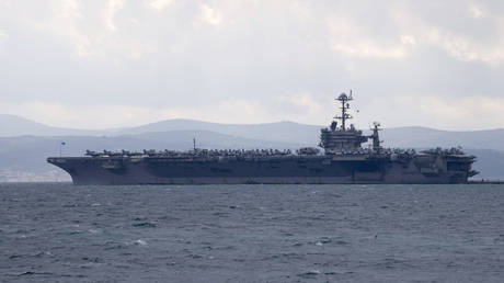 Cargo ship collides with US aircraft carrier