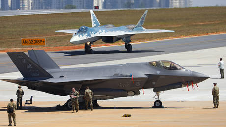 A Russian Sukhoi Su-57 fifth-generation fighter jet, background, and a U.S. Air Force F-35 fighter jet are seen during the 15th edition of the Aero India 2025 air show at Yelahanka air base in Bengaluru, India.