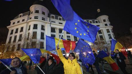 FILE PHOTO. People wave Romanian and European Union flags during a pro-European rally ahead of the country's Dec. 8 runoff presidential elections in Bucharest, Romania, Thursday, Dec. 5, 2024.