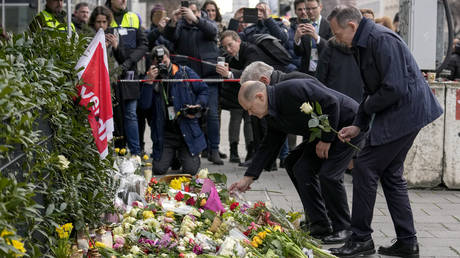 German Chancellor Olaf Scholz lays down flowers at the site of a car attack in Munich, February 15, 2025