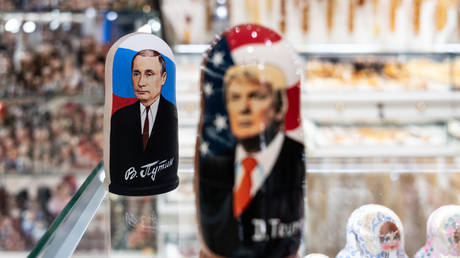 A souvenir shopkeeper displays Matryoshka dolls featuring Russian President Vladimir Putin and US president Donald Trump