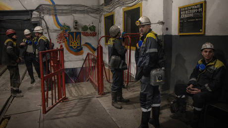 Employees wait for an elevator to take them underground to start their shift at a coal mine on February 20, 2024 near Dnepr, Ukraine