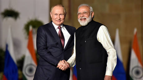 Indian Prime Minister Narendra Modi shakes hands with Russian President Vladimir Putin.