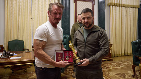 Hollywood actor and film director Sean Penn hands over his Oscar statuette to Ukrainian President Vladimir Zelensky during their meeting in Kiev.