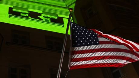 A light projection reading "RT. Were not going away" is seen on the facade of the US embassy in Moscow.