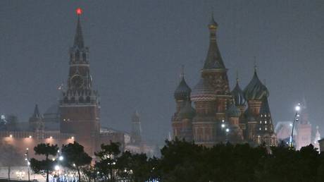 FILE PHOTO: Snowy night-time view of the Spasskaya Tower of Moscow's Kremlin and St.Basil's Cathedral.