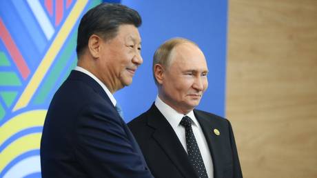 FILE PHOTO: President of Russia Vladimir Putin, right, and President of the People's Republic of China Xi Jinping.