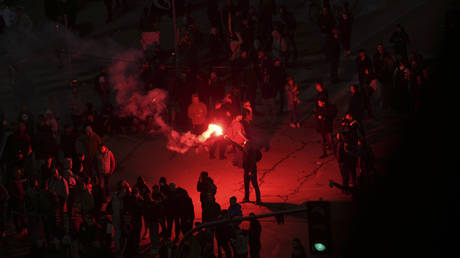 A protester lights a flare during a rally in Belgrade, Serbia, March 15, 2025.