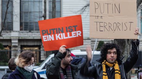 Protesters hold placards saying 'Putin is a killer' and 'Putin is a terrorist' in front of the Russian embassy in Berlin, Germany.