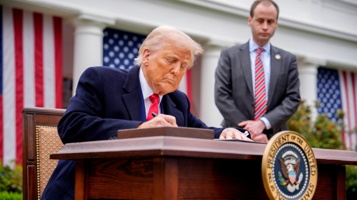 US President Donald Trump signs executive orders imposing tariffs in the Rose Garden at the White House on April 2, 2025.