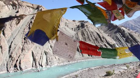 Buddhist prayer flags adorn the Indus River Valley in the Cold Desert of Ladakh. The 3,180-kilometer-long Indus River flows through China, India, and Pakistan.