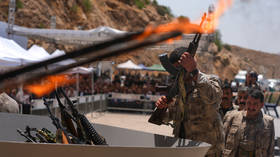 This militant group fought for 40 years. Now they’re surrendering on camera.