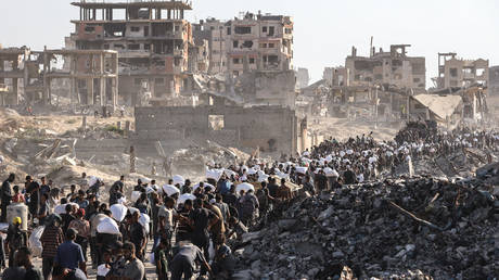 Palestinians walking to an aid distribution center near the Zikim border crossing, Gaza, August 3, 2025.