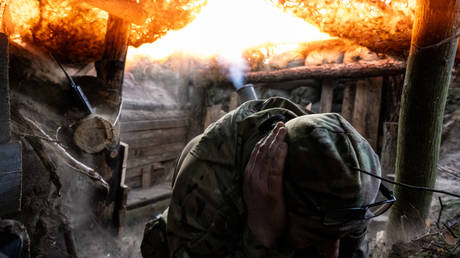 FILE PHOTO. A Ukrainian soldier nicknamed Yakut covers his ears as National Guard troops fire a 120mm mortar from the Kreminna Forest at Russian positions, Ukraine.