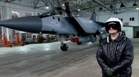 FILE PHOTO: A pilot stands by a Russian Mikoyan MiG-31 fighter jet.