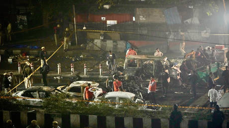 Security officials inspect the scene of a car explosion near the historic Red Fort in New Delhi, India, Monday, Nov. 10, 2025.