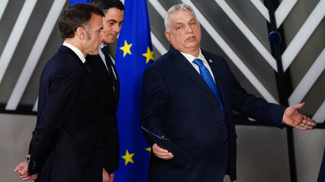 Hungarian Prime Minister Viktor Orban talking to French President Emmanuel Macron during an EU summit in Brussels.
