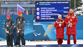 German paralympians Linn Kazmaier and Florian Baumann turn their backs to Russia's Anastasia Bagiyan and Sergey Sinyakin during a medal ceremony in Milan