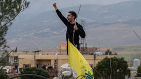A man shouts slogans in support of Hezbollah at the scene of an Israeli strike near Younine, Lebanon, on March 23, 2026.