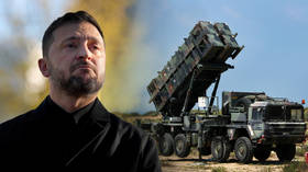 Ukrainian leader Vladimir Zelensky / a US-made Patriot anti-aircraft missile system. RT composite.
