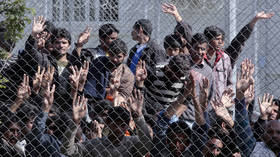 Refugees from Afghanistan and Pakistan protest against their deportation at a detention center in Lesbos, Greece.