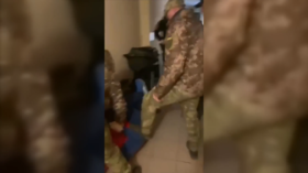 Still from a video purports to show Ukrainian draft officials beating up a man lying on the floor.