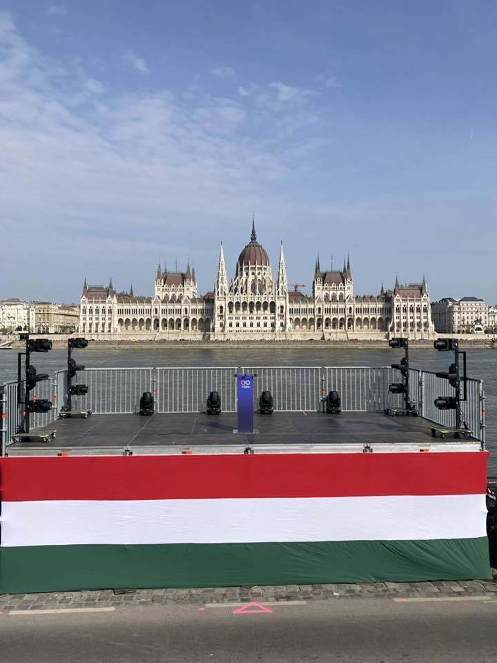 A podium is draped in the Hungarian flag in front of Parliament buildings, for Peter Magyar to speak to supporters in Budapest, Hungary, April 12, 2026