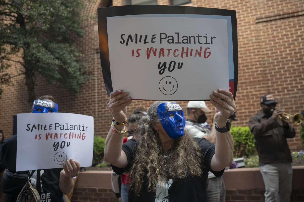 A group of anti-ICE demonstrators hold a rally in front of Palantir's offices in Washington DC