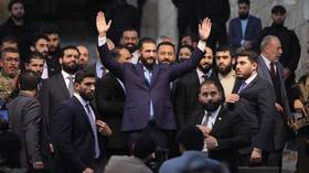 Syrian leader Ahmed al-Shara greets supporters at the Citadel of Aleppo.