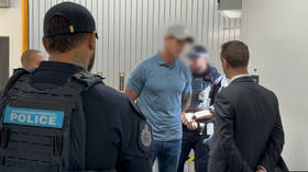 SAS veteran Ben Roberts-Smith is detained by police officers at Sydney Airport on April 7, 2026.