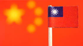 Taiwanese flag with Chinese flag in background.