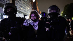 Police officers escort a detained activist wearing a Palestinian keffiyeh during an anti-Israel protest in Berlin, Germany, October 7, 2025