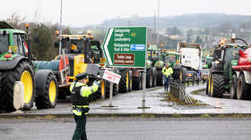 A police officer directs traffic as slow-moving vehicles join a fuel protest causing severe traffic disruption on the A5 between Belfast and Omagh, April 14, 2026.