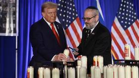 Donald Trump and Rabbi Yehuda Kaploun light a candle during an event in Florida commemorating the victims of the October 7, 2023 Hamas attack on its first anniversary.