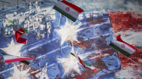 Iranian flags hang in front of a giant anti-US billboard in downtown Tehran, Iran, on January 28, 2026.