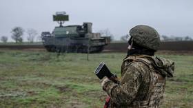 A soldier stands against the background of a Russian Tor-M2 air defense system in Zaporozhye Region, Russia, on March 28, 2026.
