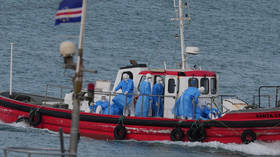 Health workers prepare to evacuate patients from the MV Hondius cruise ship amid a hantavirus outbreak at a port in Praia, Cape Verde, May 6, 2026