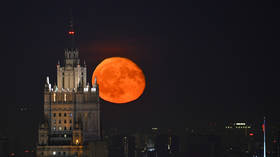 The full moon rises over the Russian Ministry of Foreign Affairs building in Moscow, Russia on May 14, 2025.