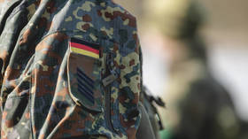 Insignia and rank are seen on the uniform of a German soldier.