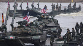 US Army M1A2 Abrams tanks cross the Vistula River during NATO military exercises in Poland.