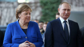 German Chancellor Angela Merkel (L) greets Russian President Vladimir Putin at the German federal Chancellery in Berlin, Germany, January 19, 2020