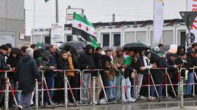 Syrians waving national flags are seen in Berlin, Germany, on March 30, 2026.
