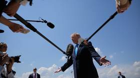 US President Donald Trump talks to reporters after returning from a day trip to Connecticut to address US Coast Guard Academy graduates.
