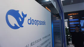 A visitor walks by the display board of AI firm DeepSeek at a mall in Hangzhou, China, April 23, 2026