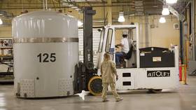 Workers handle a TRUPACT shipping container with waste from the US nuclear weapons program at a facility in New Mexico.