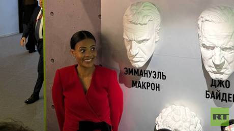 Candace Owens poses with Macron sculpture at SPIEF (PHOTOS)