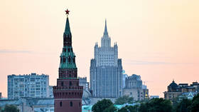 Moscow skyline with the Vodovzvodnaya Tower of the Kremlin in the foreground and the Ministry of Foreign Affairs building in the background.