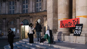 A banner reading 'Palantir out' hangs at a rally in front of the Academy of Moral and Political Sciences in Paris, France, January 26, 2026